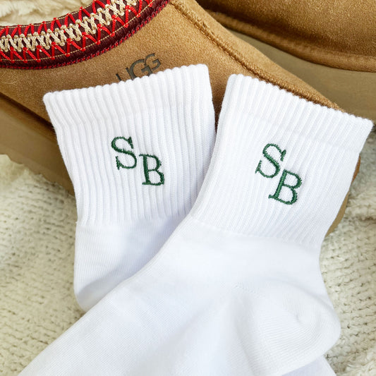 White midi crew socks with custom embroidered staggered initials in Ivy green thread.