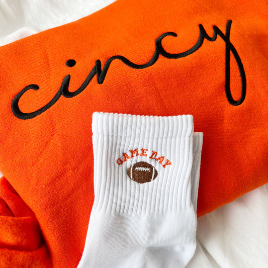 orange cincy embroidered sweatshirt paired with ankle crew socks with custom embroidered football game day design