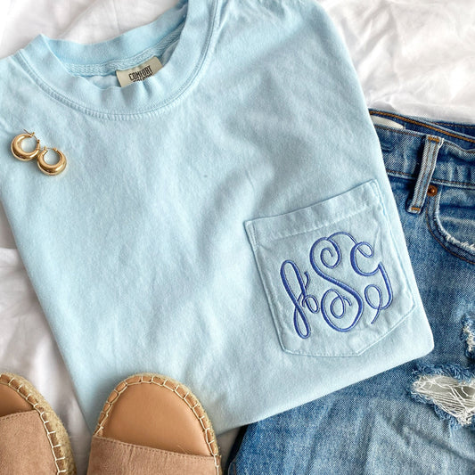 Chambray blue comfort colors pocket tee with ASG embroidered fancy monogram in periwinkle thread