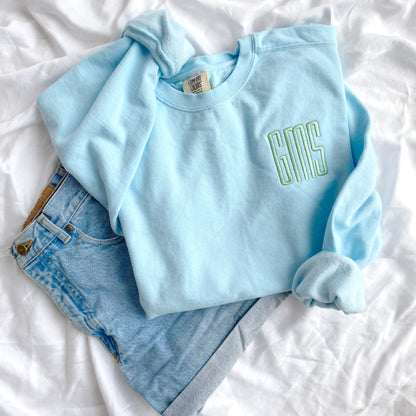 Chambray comfort colors crewneck sweatshirt with GMS embroidered monogram in silver sage thread