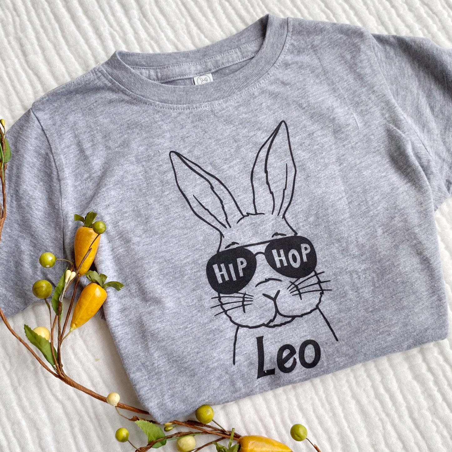 gray toddler t-shirt with an outlined bunny wearing sunglasses and a custom name design on the front