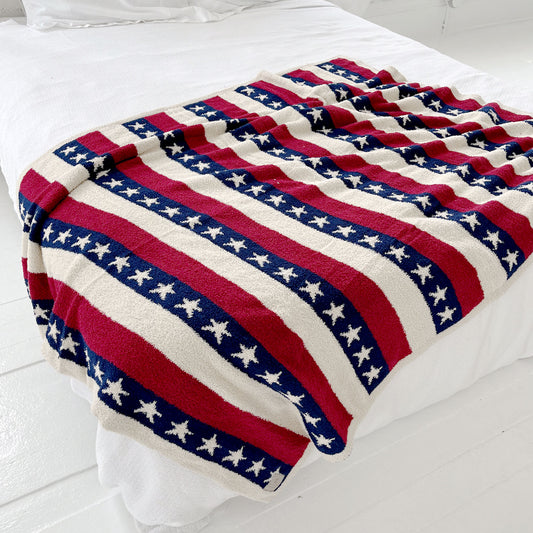 usa star cozy microfiber throw blanket draped over a bed