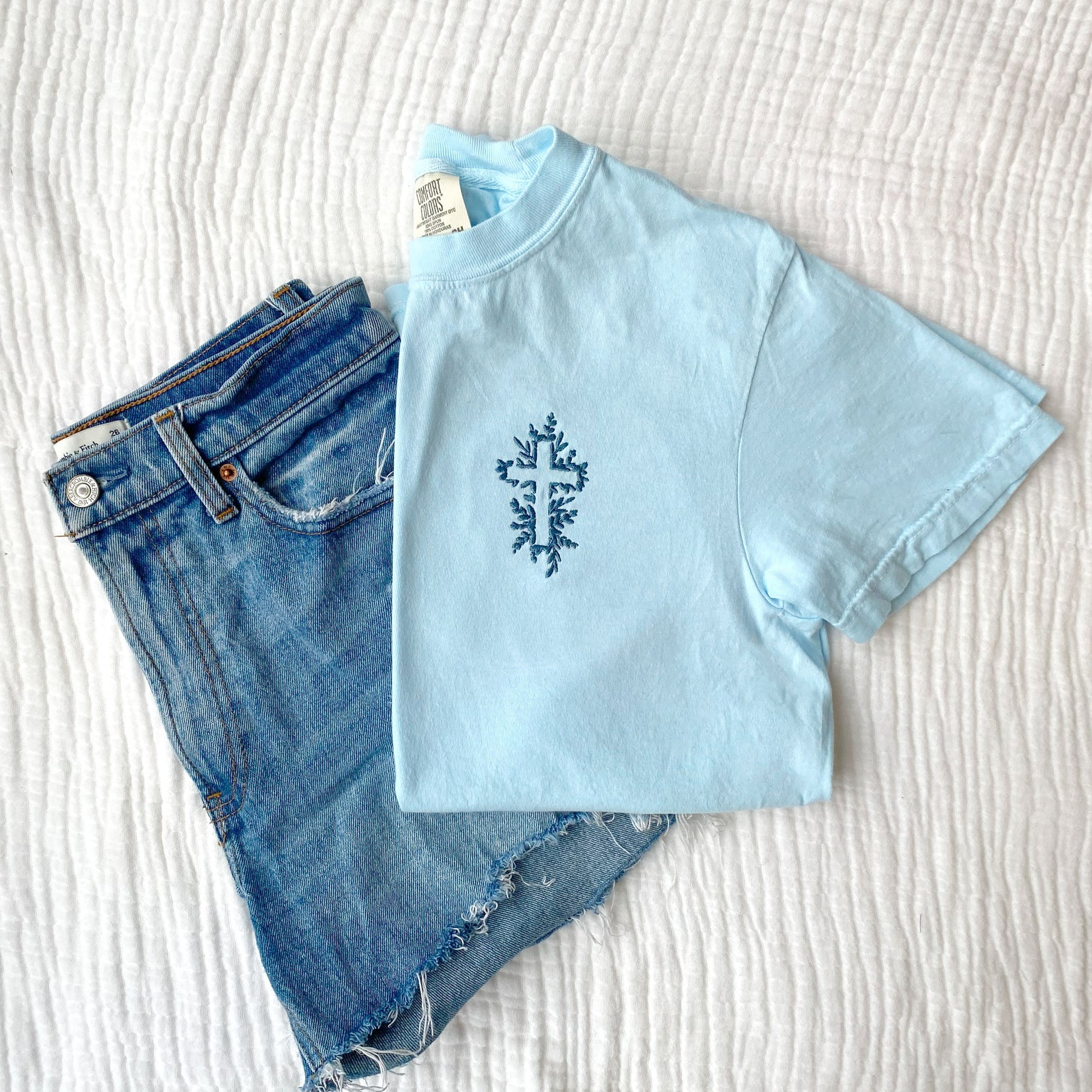chambray comfort colors t-shirt with a floral embroidered cross in french blue thread and a pair of jean shorts