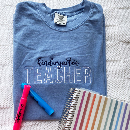 washed denim comfort colors t-shirt with kindergarten and teacher embroidered on the center chest