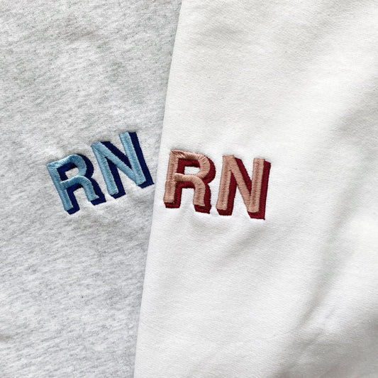 close up of shadow block embroidered credentials on a sweatshirt
