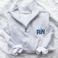 light heather grey quarter zip sweatshirt with custom shadow block nurse credentials embroidered on the left chest
