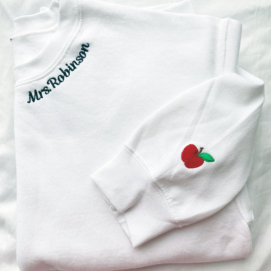 teacher sweatshirt with neckline name embroidery and mini apple on the cuff