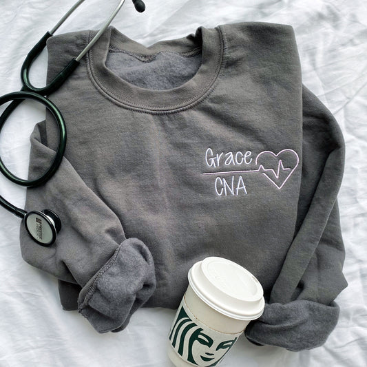 Gray crewneck sweatshirt with name and heartbeat embroidered design on the left chest
