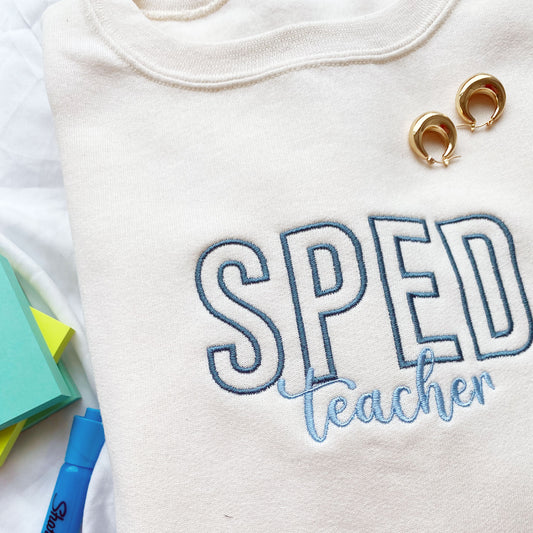 sweet cream crewneck sweatshirt with SPED teacher embroidered on the center chest