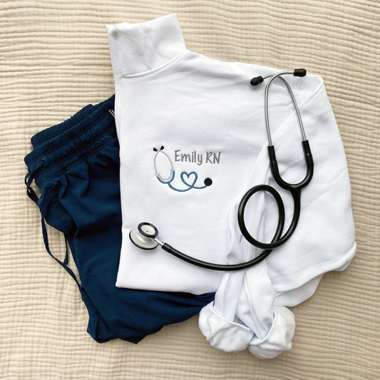 nurse quarter zip pullover with heart loop stethoscope and name embroidered design on the left chest.
