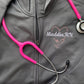closeup of a grey polyester full zip with a cadet collar and a personalized heart shaped stethoscope and name embroidered design on the left chest.
