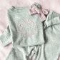 heather gray baby set with long sleeve top and flare leggings, featuring a personalized bow monogram embroidered design in powder pink on the center chest of the top.