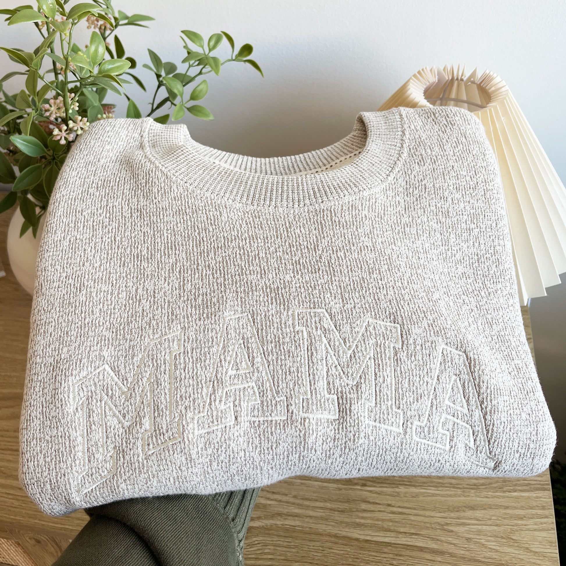 A latte knit pullover crewneck sweatshirt with a custom mama athletic block embroidered design in a natural thread