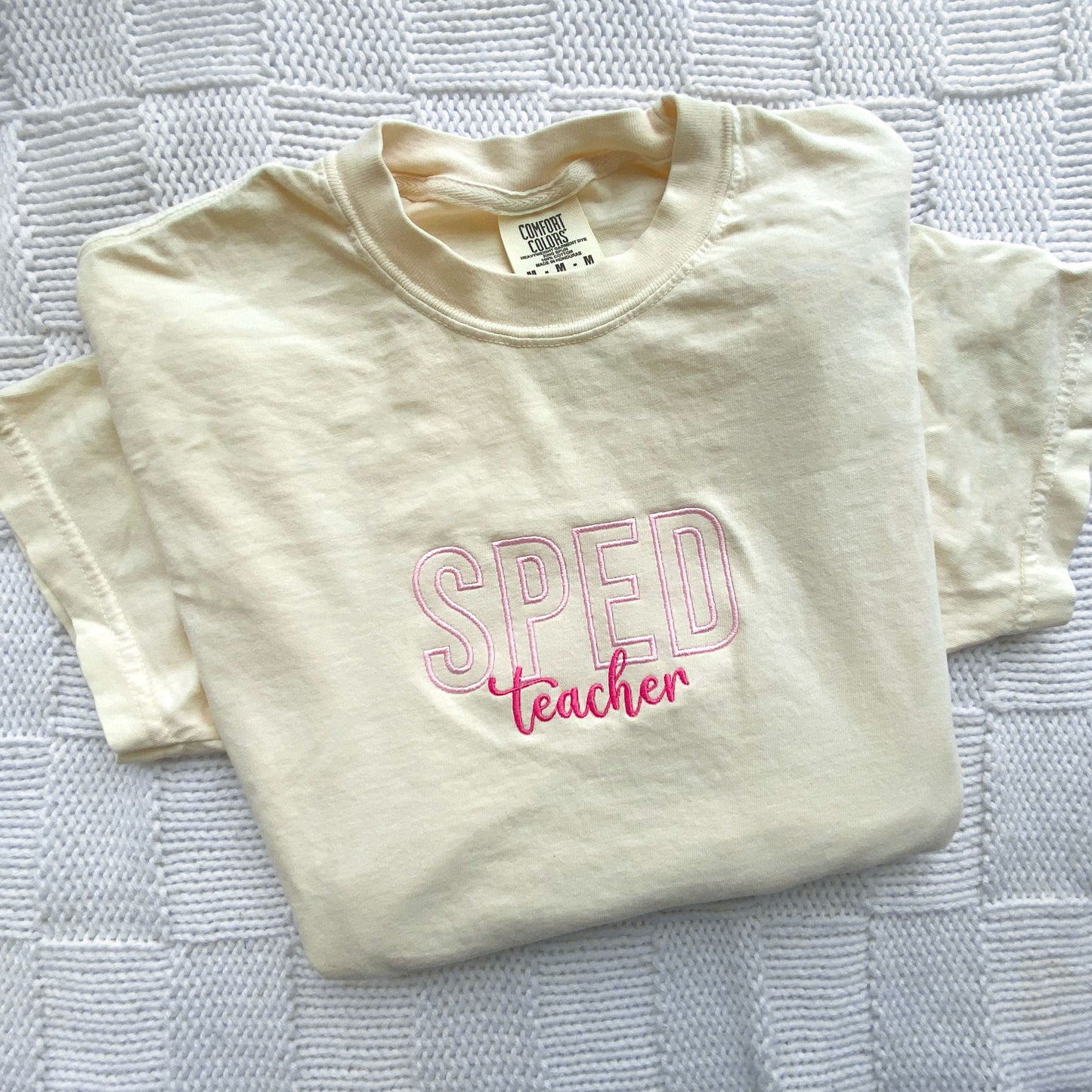  comfort colors ivory tshirt with embroidered sped teacher design in baby pink and pink threads