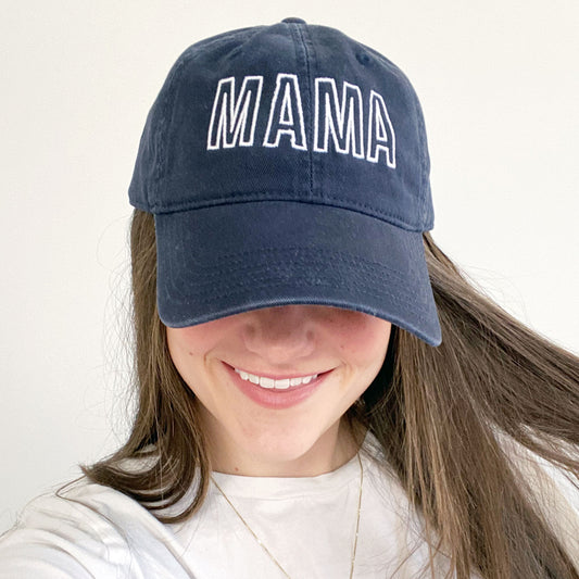 woman wearing a blue hat with mama embroidered on it