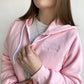 close up of a young woman wearing a pink bella and canvas full zip jacket with embroidered Mama est 2024 design on the left chest in white thread