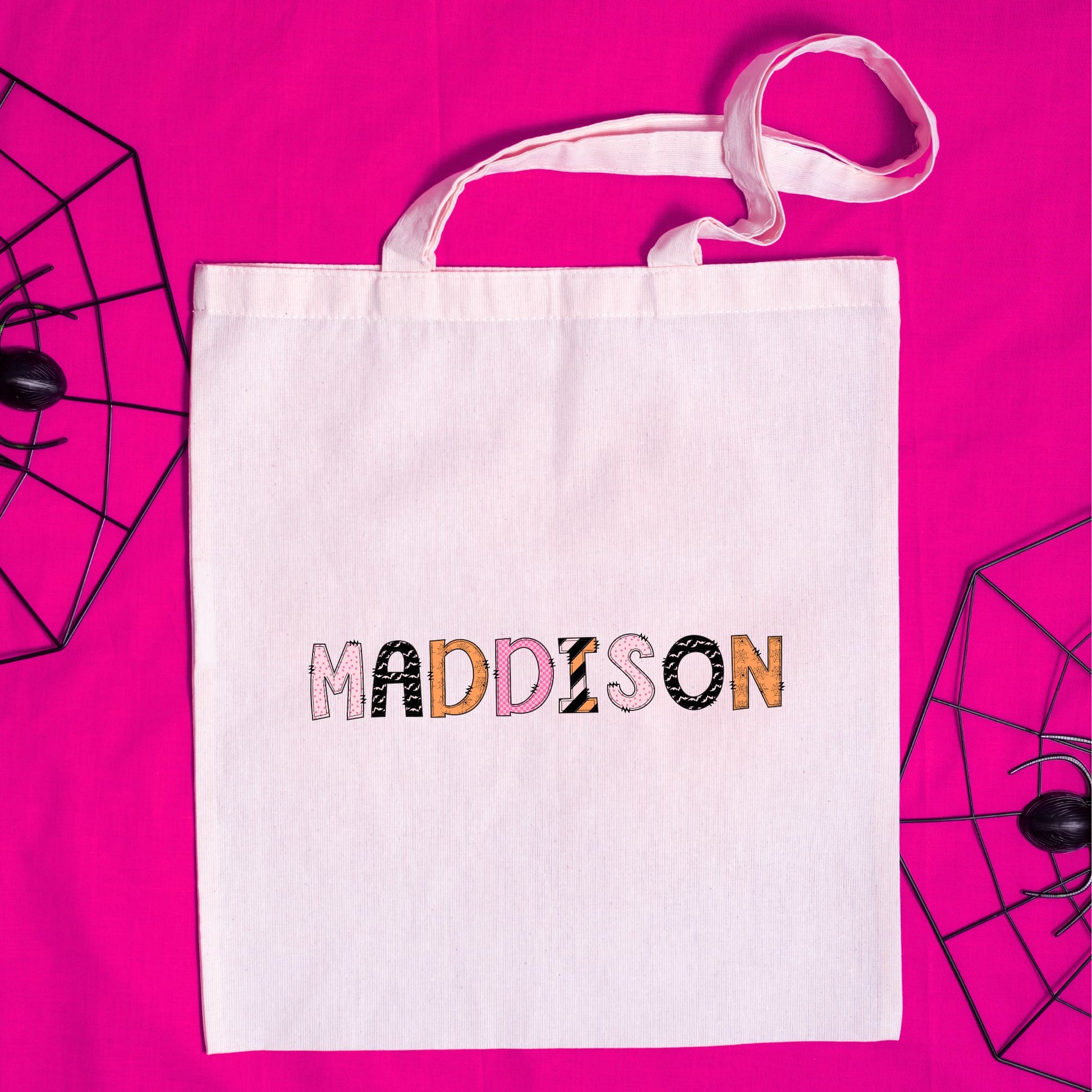 Natural tote bag for trick or treating with a printed custom name design in a mixed pattern font