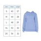 A size chart table showing sizes S through 2X with chest and length measurements, next to a light blue pullover hoodie on a white background.