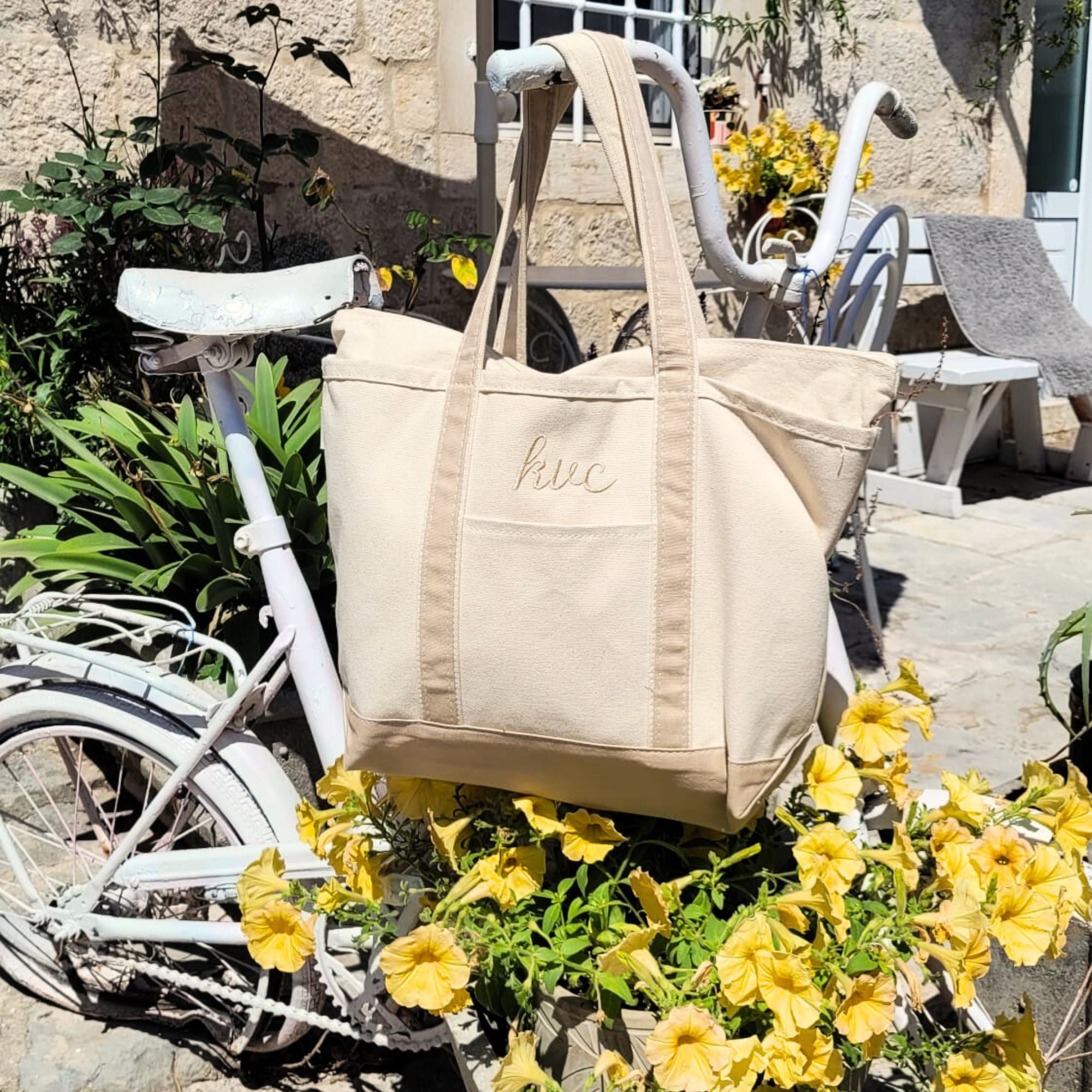 canvas tote bag with natural trim and embroidered monogram