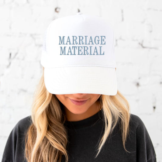 WHITE TRUCKER HAT WITH EMBROIDERED MARRIAGE MATERIAL EMRBOIDERED IN BABY BLUE THREAD 