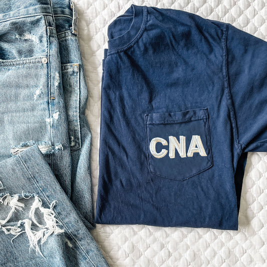 navy blue comfort colors pocket tee with a custom credential shadow block embroidered design on the pocket