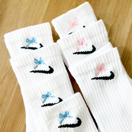 Nike socks with mini blue and pink bows embroidered above the check