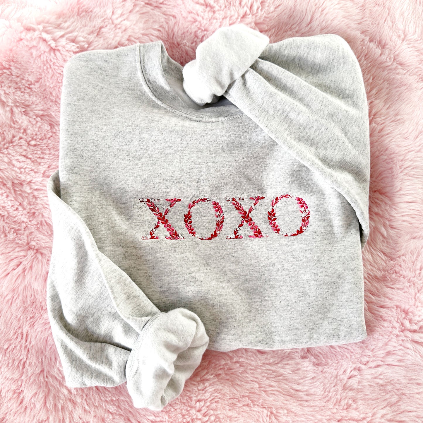 Ash crewneck sweatshirt with valentines  embroidered floral xoxo design across the chest
