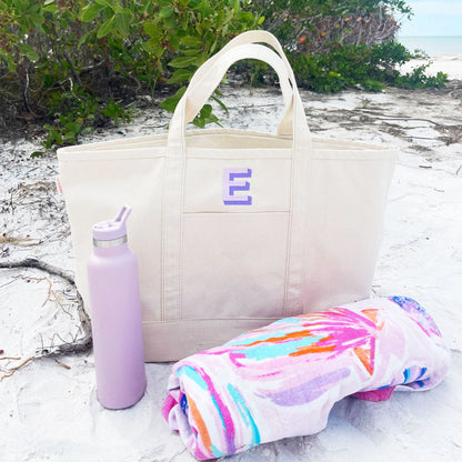 large natural canvas boat tote bag with a shadow block purple initial embroidery 