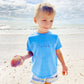 little boy on a beach wearing a carolina blue t-shirt with a custom stitched name embroidery across the chest