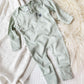 sage green baby pajamas with fold over mittens and footies with custom mini embroidered monogram on the left chest