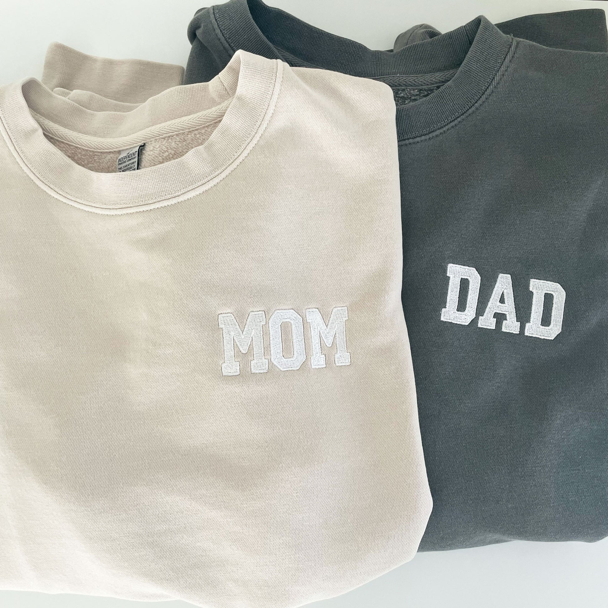 Mom and dad embroidered crewneck sweatshirts in cement and black colors. 