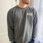 Man wearing pigment black sweatshirt with white dad embroidered text