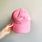 pink baseball cap with white embroidered heart design