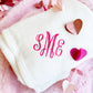 White blanket with SME monogram embroidered in pink