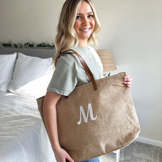 girl holding a natural jute personalized embroidered tote