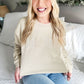 bride wearing a sand colored crewneck sweatshirt with a custom BRIDE embroidered design across the chest in a mix of neutral threads
