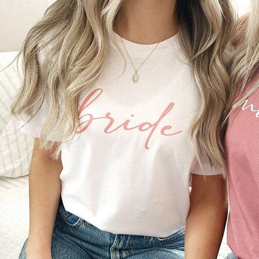bella and canvas white crewneck t-shirt with bride printed  in all lower case script in mauve ink across the chest