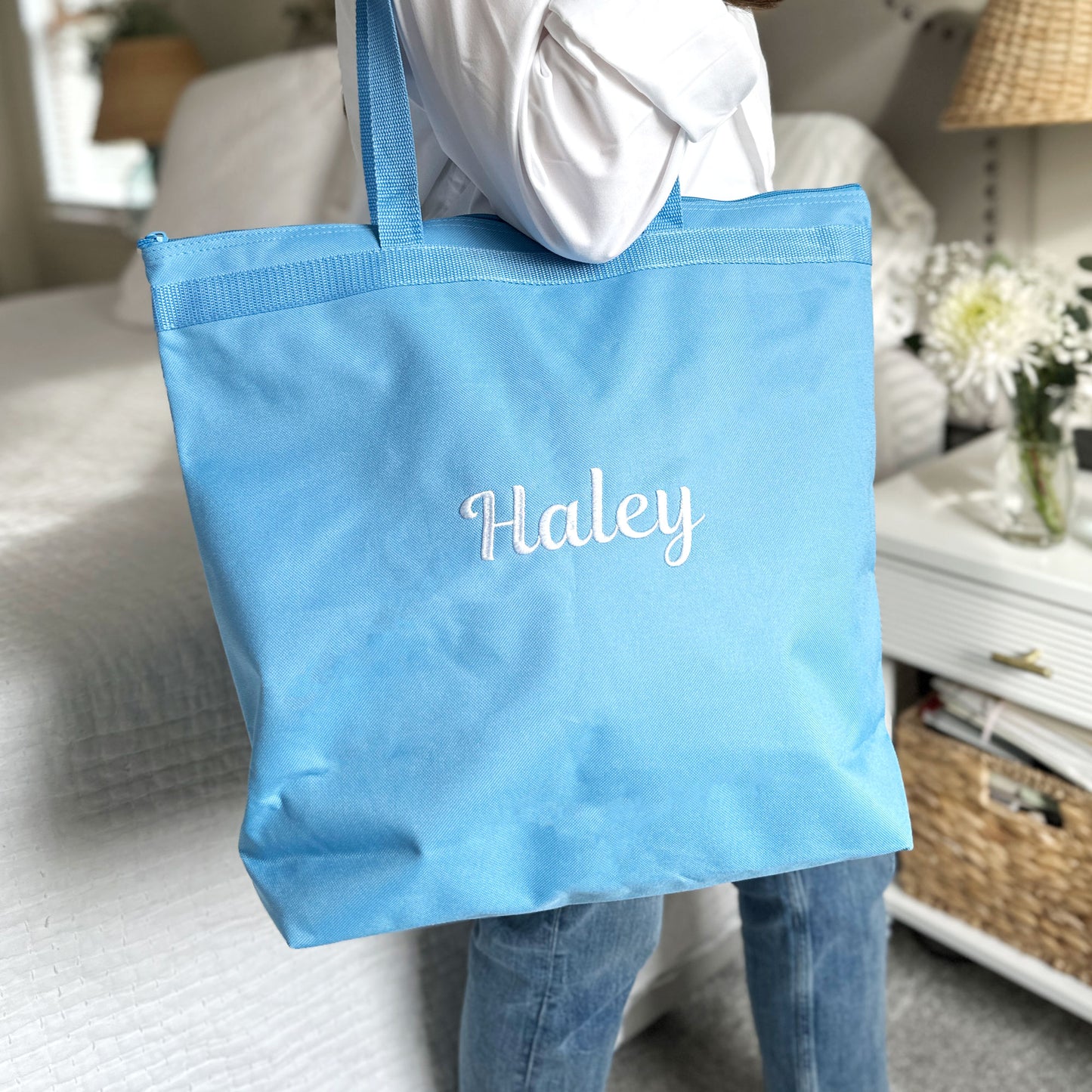 light blue tote bag with full name  embroidered in white thread
