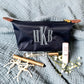 styled nylon makeup pouch with embroidered monogram