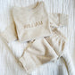 Lightweight long sleeved baby top with custom name embroidery and matching pants in a heather oat material