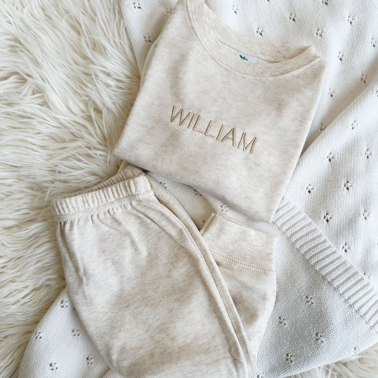 Baby jogger set in an oat color with a minimal modern name embroidery across the chest