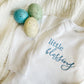 white infant bodysuit with little blessing embroidered in a mixed font in baby blue thread