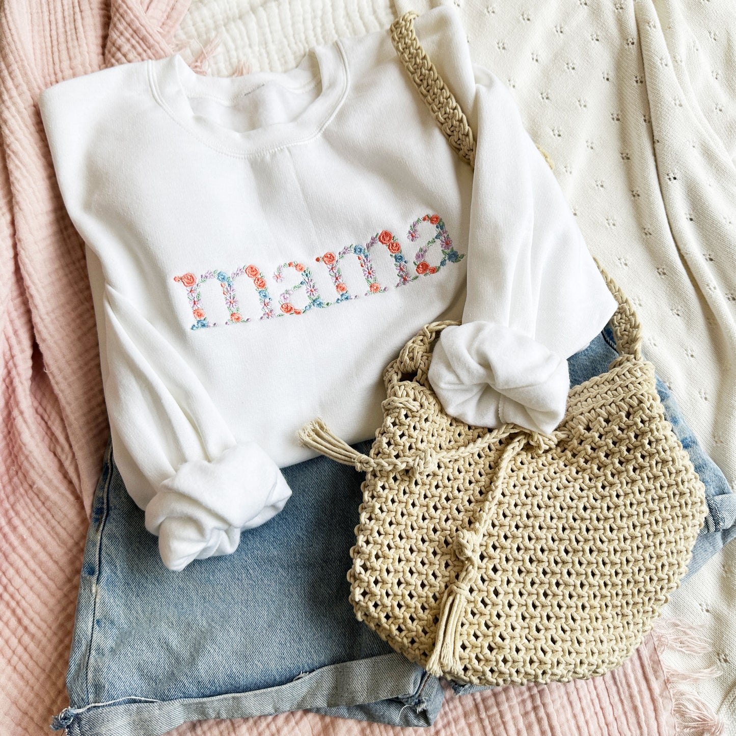 Whit ecrewneck sweatshirt with embroidered floral mama in spring colors styled with jean shorts and a cute purse!