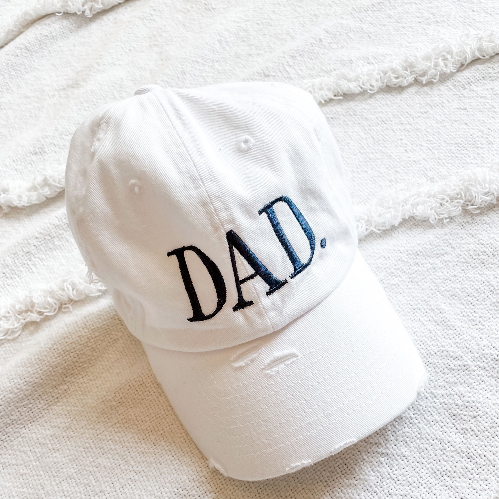 white distressed cap with custom large dad embroidered design