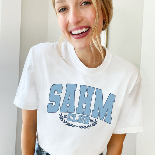 woman wearing a white comfort colors t-shirt with custom SAHM club and date dtg print large on the front