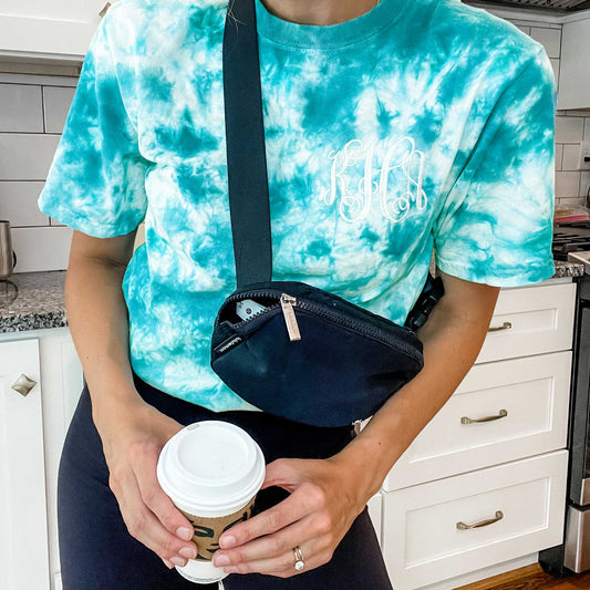 woman wearing a teal crystal blue tie dye tee with personalized mongoram