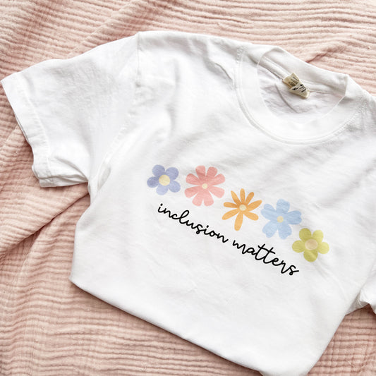 cute white comfort colors t-shirt with a printed inclusion matters floral print