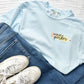 teacher outfit featuring blue jeans and a chambray comfort colors teacher tee with a cute pencil and custom name printed design on the left chest