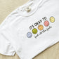 white crewneck t-shirt with a cute smiley face it's okay to feel all the feels printed design