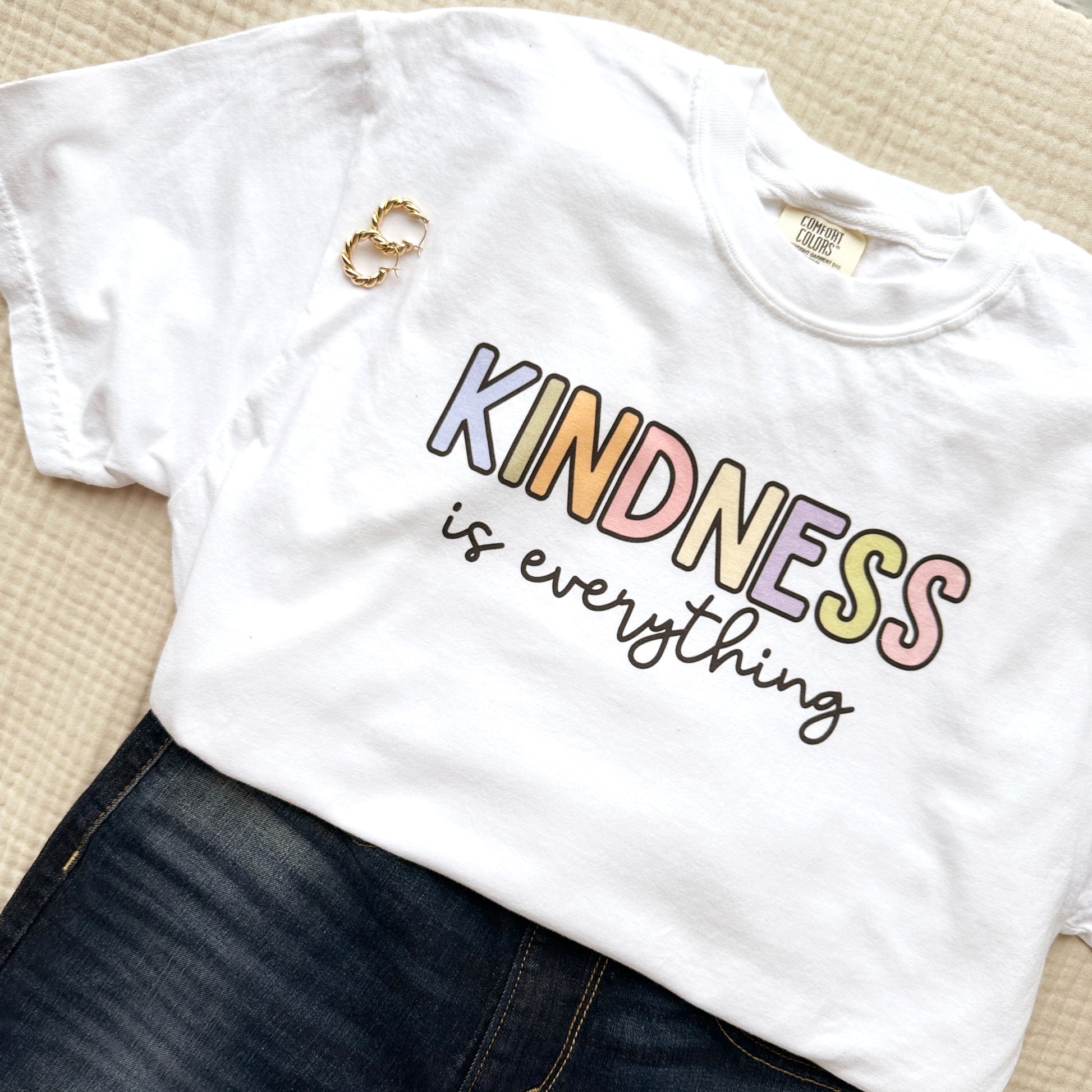 white comfort colors t-shirt with a colorful kindness is everything printed design